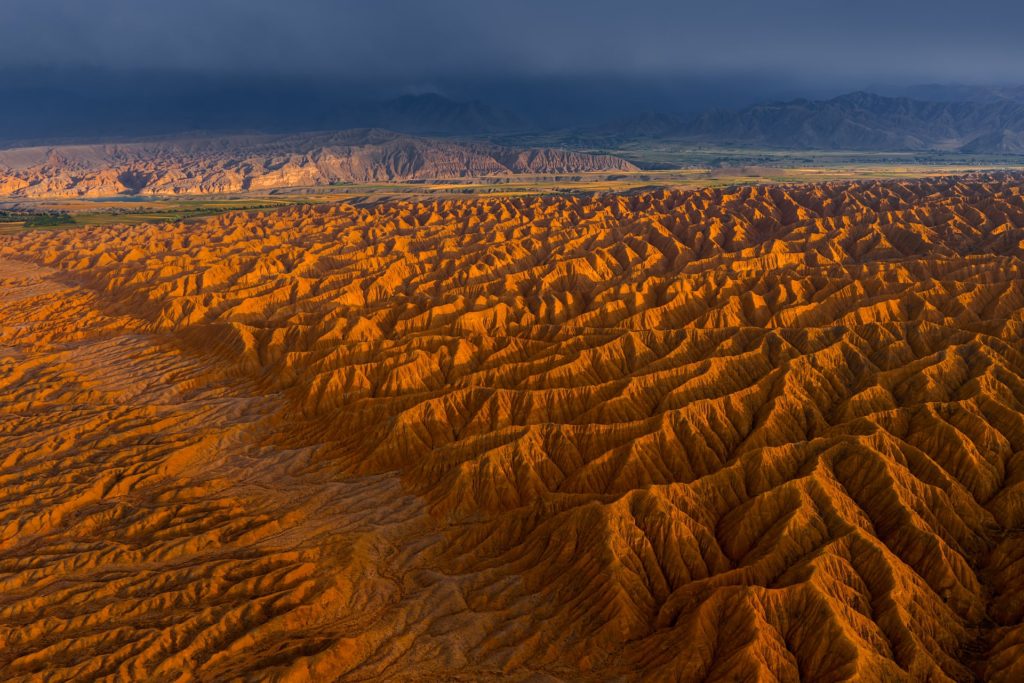 Layers of orange and brown hills in a valley landscape