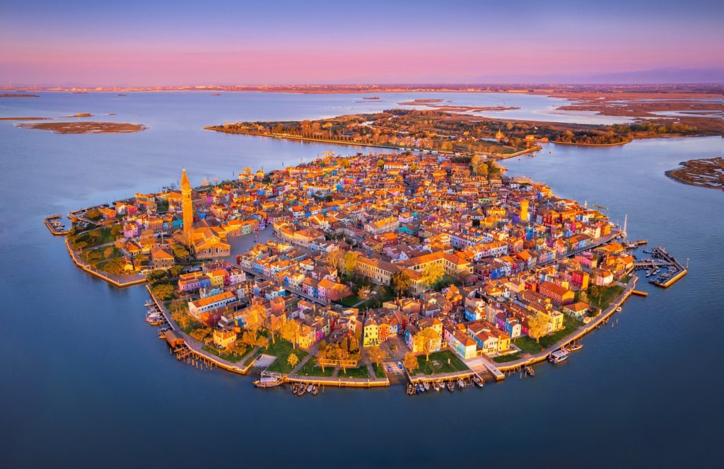 Burano island at sunrise, Venice, Italy with colourful houses and canals