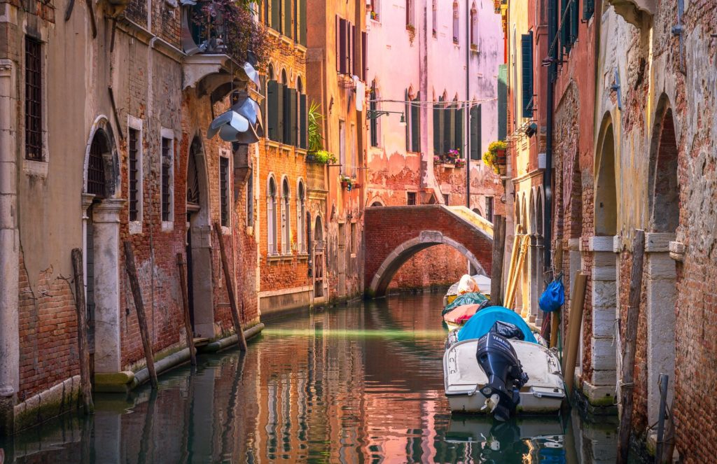 Venetian canal shaded by buildings, Venice, Italy