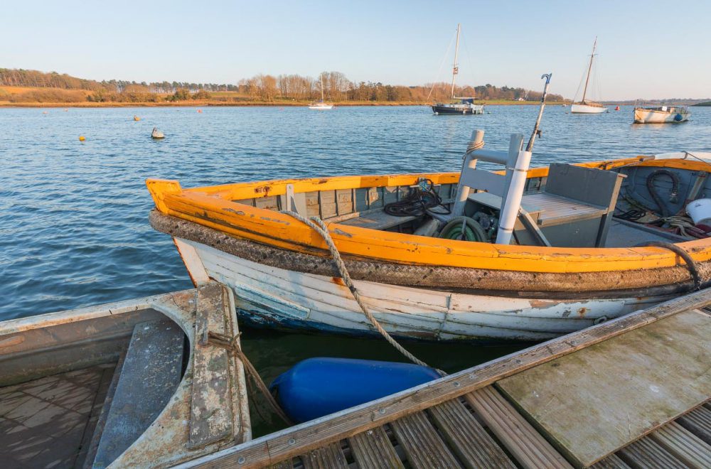 Moored boat on the River Deben catching the evening sun