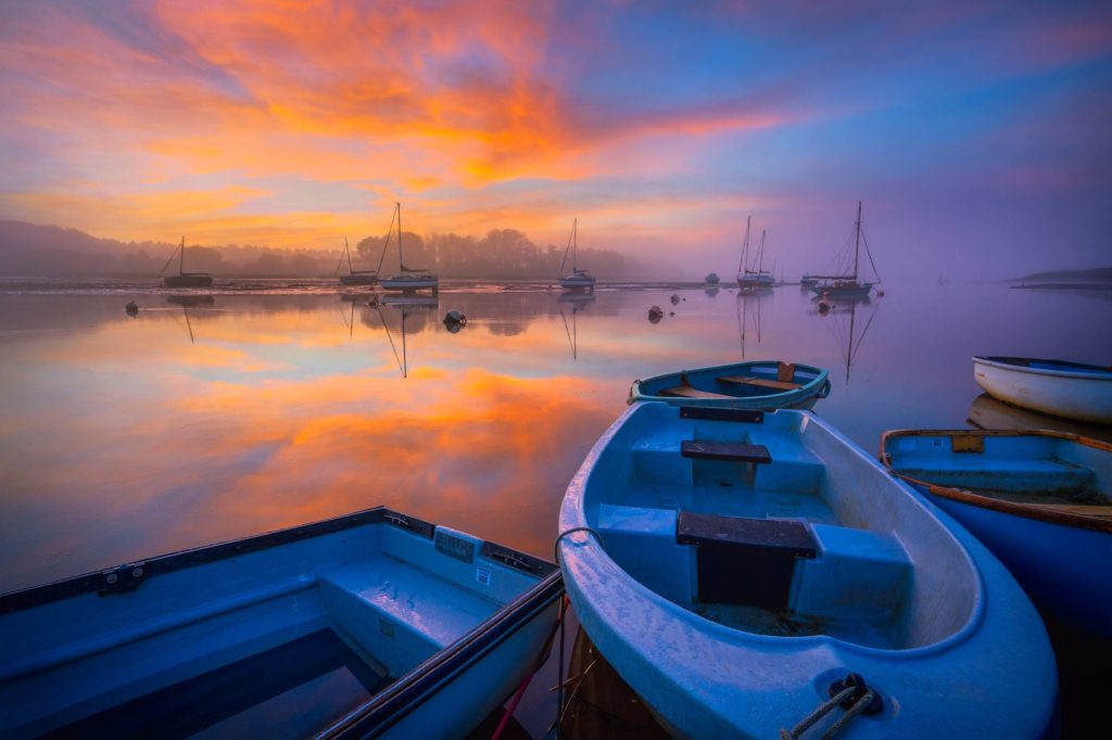 Sunrise over River Deben with moored boats, Woodbridge, Suffolk, England