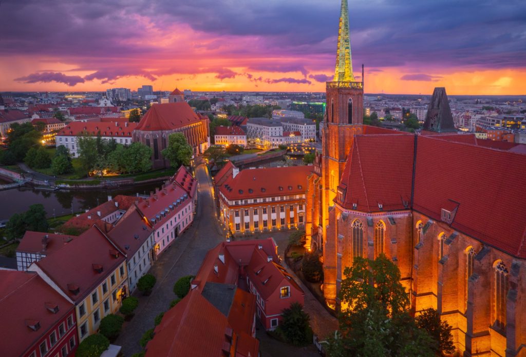 Stormy evening sky over Wrocław, Poland, with illuminated buildings